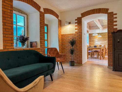 a living room with a couch and a dining room at Penzion Festung in Petrovice