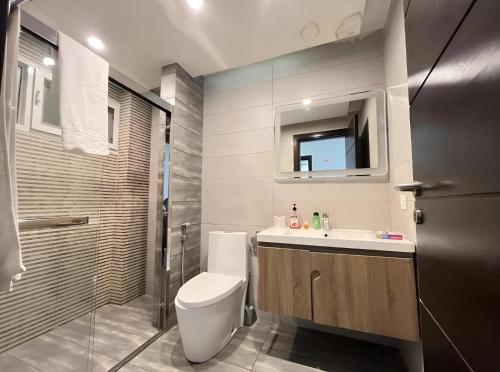 a bathroom with a toilet and a sink and a shower at LMY Elysium Apartments Facing Centaurus Mall Islamabad in Islamabad