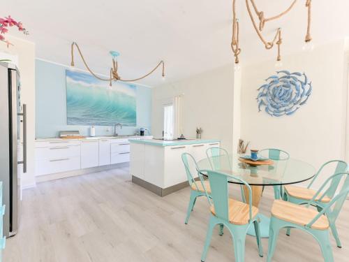 a kitchen with a glass table and chairs at Villa Tiffany by Interhome in Punta Ala