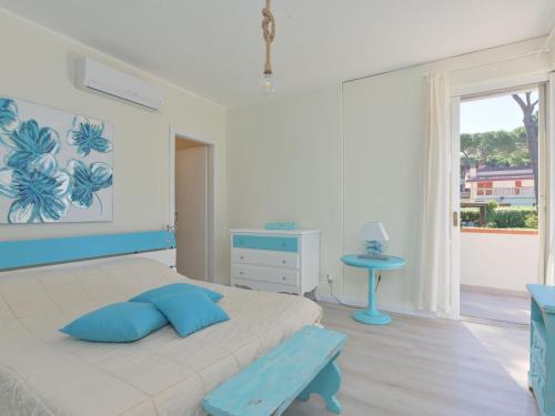 a bedroom with a bed and a table and a window at Villa Tiffany by Interhome in Punta Ala