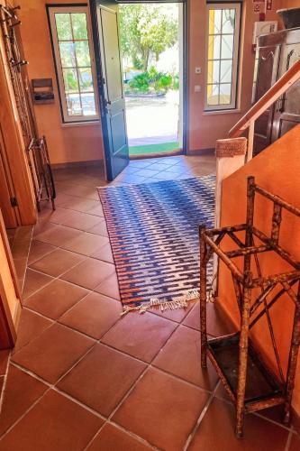a hallway with a tile floor and a door with a rug at Holiday Home Entre as Árvores by Interhome in Comporta