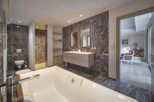 a large bathroom with a tub and a sink at FRGK Luxury Villa Cannes Croix des Gardes in Cannes