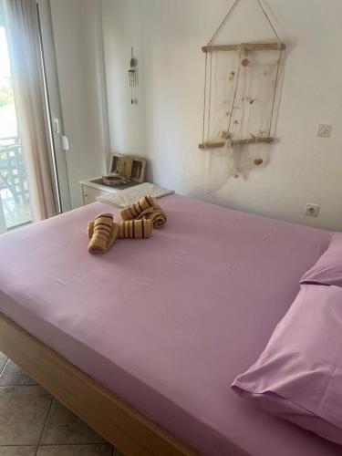 a bedroom with a purple bed with a purple blanket at Harmony Apartment in Kallithea Halkidikis