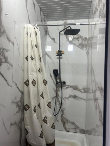 a bathroom with a shower with a shower curtain at One Million Stars Yurt camp in Song-Kul