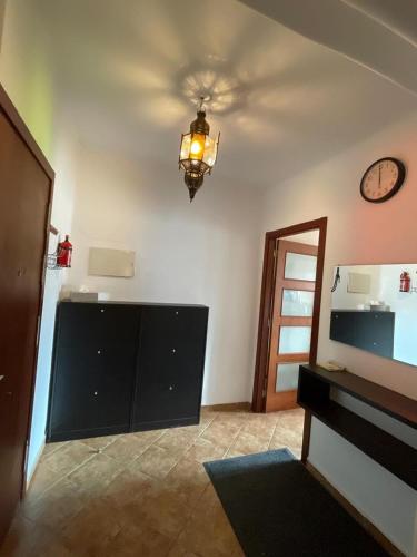 a living room with a clock on the ceiling at La Cassia in Cabo Negro