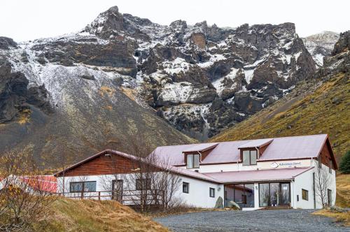 a barn with a mountain in the background at Adventure Hotel Hof in Hof