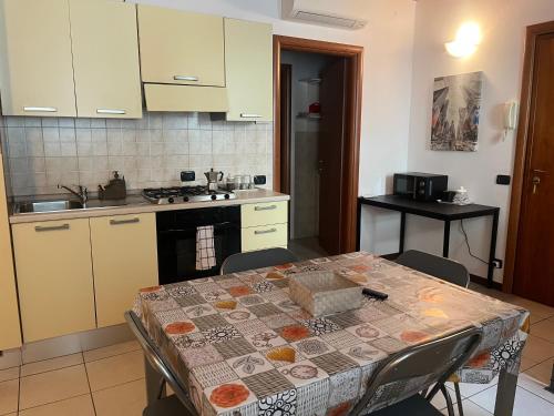 a kitchen with a table with a table cloth on it at Apartment Orio 1 e 2 in Orio al Serio
