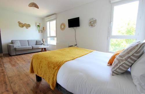 une chambre avec un grand lit et un canapé dans l'établissement DAM3 - Studio 4 pers - Disneyland Paris RER, à Montévrain