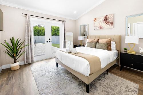 a bedroom with a large bed and a sliding glass door at Alluring Luxury Oasis, Modern Comfort & Relaxation in Wellington
