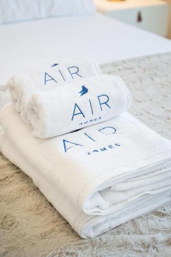 a pile of towels sitting on a bed at Luxury unit in the Heart of Dubai Hills in Dubai