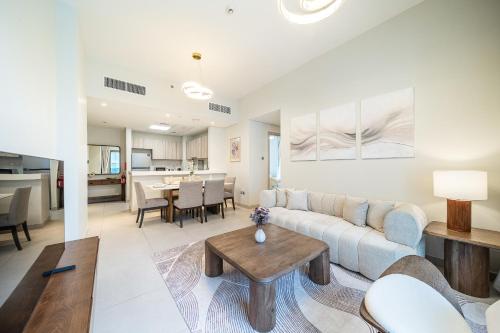 a living room with a couch and a table at Luxury unit in the Heart of Dubai Hills in Dubai