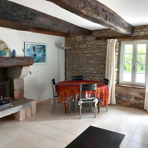 une salle à manger avec une table et des chaises rouges dans l'établissement Maison Le Clos Nalet, à Matignon