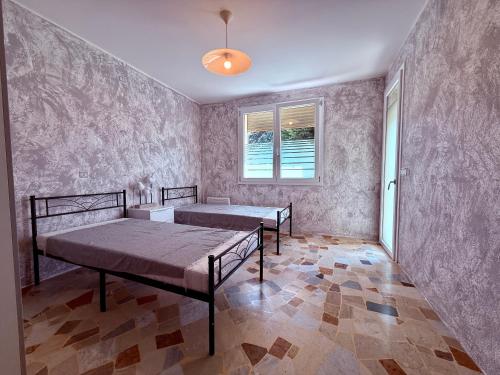 a bedroom with two beds and a window at Guest House - MXP, Lakes, Leonardo, 2 bedrooms in Sesto Calende