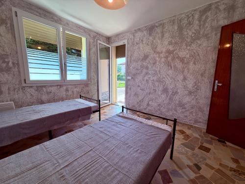 a bedroom with two beds and a window at Guest House - MXP, Lakes, Leonardo, 2 bedrooms in Sesto Calende