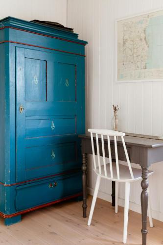 a blue dresser next to a desk and a chair at Tiny House Vibe At Beach Near Saksild Home in Odder