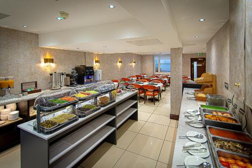 a buffet line in a restaurant with many plates of food at Hyde Park International in London