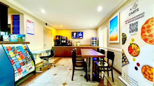 a fast food restaurant with a table and chairs at Days Inn by Wyndham Los Angeles LAX South Bay Beach City LA in Lawndale