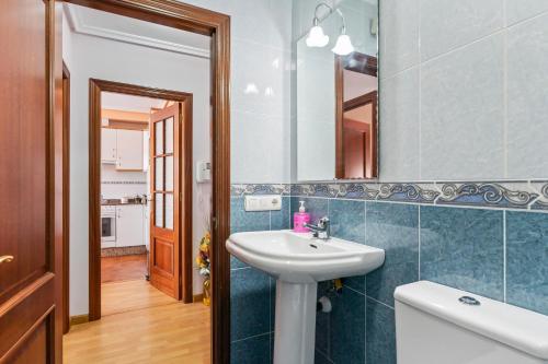 a bathroom with a sink and a mirror at Brisas Carlos I I I in Ribadeo