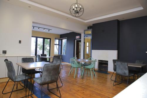 a dining room with a table and chairs and a fireplace at The Mandy Guesthouse in Kokstad