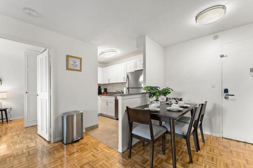 a kitchen and dining room with a table and chairs at Furnished Apartment in Brookline