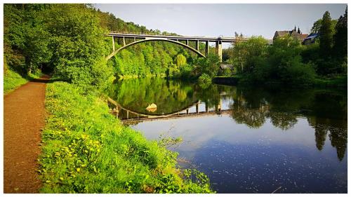 a bridge over a river with trees and a road at ROMANTIK HOTEL ELEONORA in Tábor