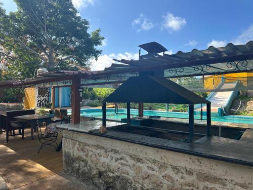 - un pavillon avec une table et une piscine dans l'établissement Casa de campo Huerta De Calín, à Valladolid