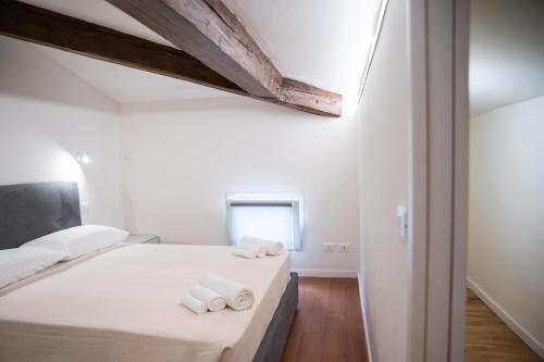 a bedroom with a bed with towels on it at Rilievo in Venezia in Livorno