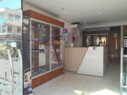 a store front with glass doors and a refrigerator at Hotel Valle Dorado in Huancayo