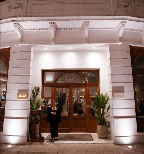 a woman standing in front of a building at Hotel Bardot Boutique in Panama City