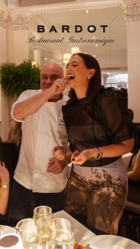 a man and a woman feeding each other food at Hotel Bardot Boutique in Panama City