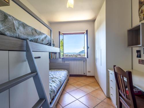 a small room with a bunk bed and a window at Holiday Home Ornella by Interhome in Pallanza