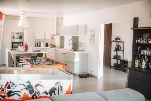 a kitchen with a table in the middle of a room at Villa les trois pins in Venelles