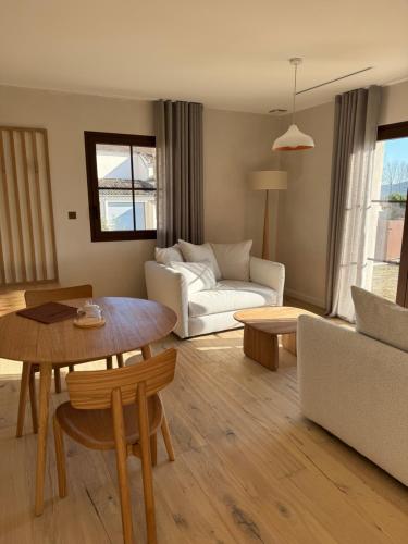 a living room with a couch and a table at Ferme La Clavière, Suite de Luxe Lou Estello in Mane