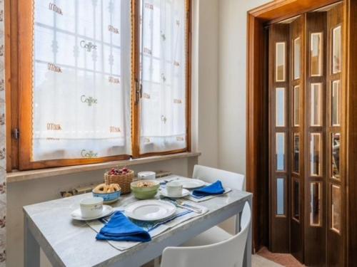 a dining room table with blue napkins and dishes on it at Apartment Roseto Down Town by Interhome in Roseto degli Abruzzi