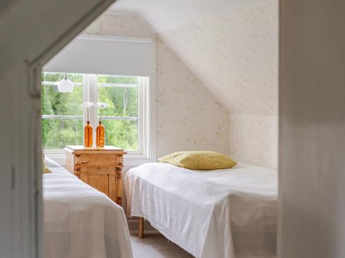 a bedroom with two beds and a window at Holiday Home Bygget by Interhome in Simlångsdalen