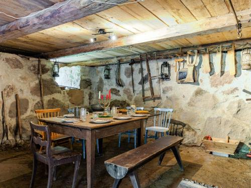 a dining room with a wooden table and chairs at Holiday Home Vetlycke by Interhome in Torsås