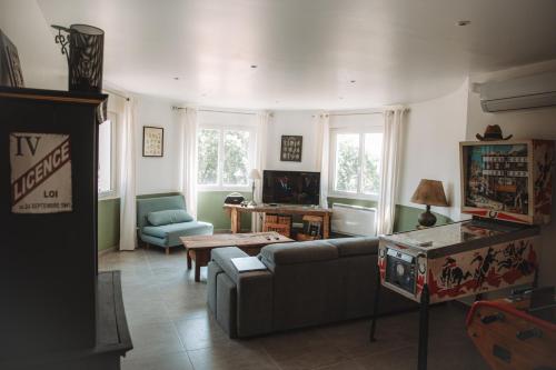 a living room with a couch and a table at Villa les trois pins in Venelles