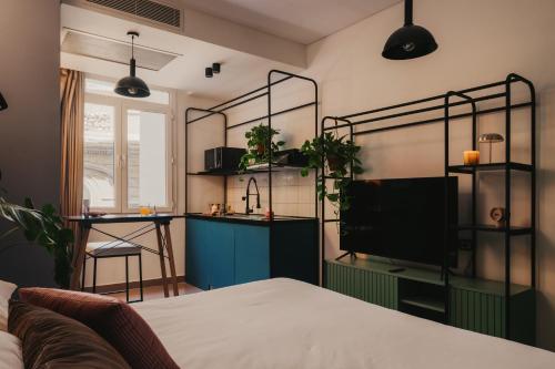 a living room with a bed and a tv at Brassbell l DT l Hannaux l Tahrir sq in Cairo