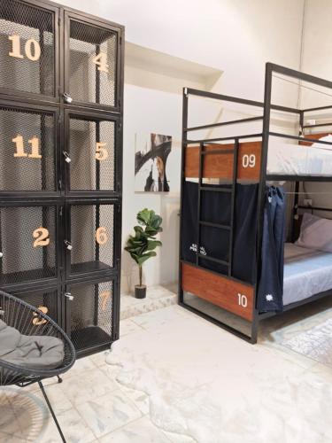 a room with two bunk beds and a chair at Habitación compartida para mujeres in Mérida