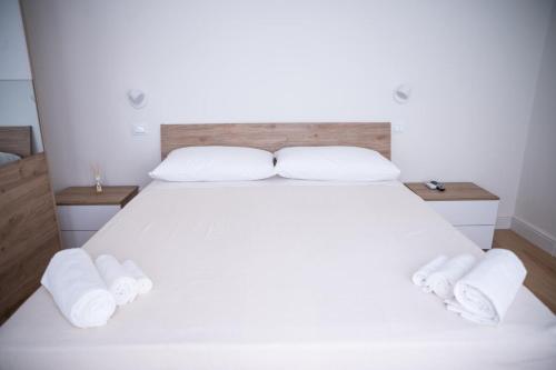 a bedroom with a white bed with towels on it at Rilievo in Venezia in Livorno