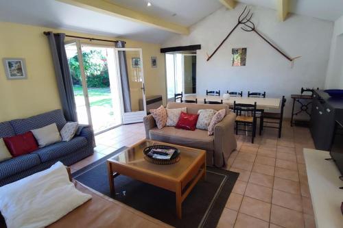 a living room with two couches and a table at Domaine Guiton Le Colombier in Chamaret