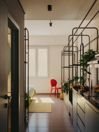 a kitchen with a red chair in a room at Brassbell l DT l Hannaux l Tahrir sq in Cairo