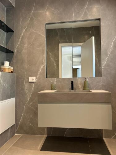 a bathroom with a sink and a mirror at Escape Suites in Dhërmi