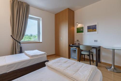 Postel nebo postele na pokoji v ubytování Hotel Pineta