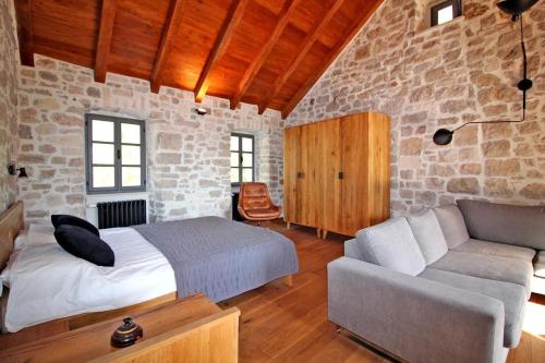 a bedroom with a bed and a couch at Villa Kuk in Bol
