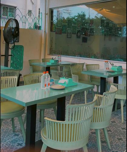a dining room with tables and chairs in a restaurant at StayBird - Azure Suites, Business Hotel in Pune