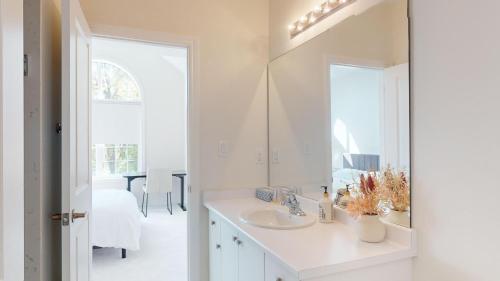 a white bathroom with a sink and a mirror at New Custom-built House Close to Rogers Stadium in Toronto