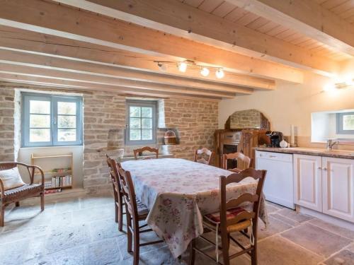 une cuisine avec une table et des chaises dans une pièce dans l'établissement Gîte au cœur de la Vallée, jardin privé, capacité 6 pers. - FR-1-583-411, à Saint-Sulpice