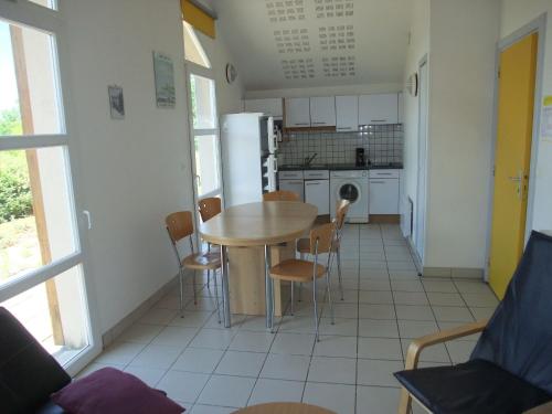 a kitchen and dining room with a table and chairs at Pavillon confortable dans la Vallée de l'Ognon - FR-1-583-413 in Larians-et-Munans