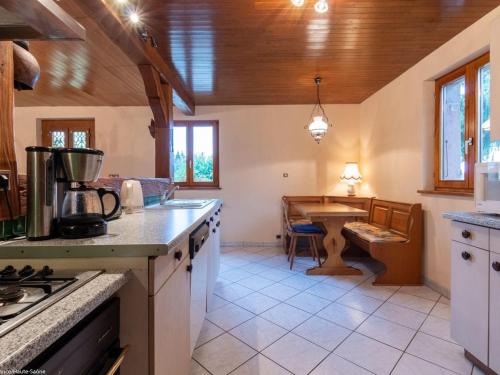 a kitchen with a counter and a table in it at Gîte chaleureux dans les Vosges avec cheminée - FR-1-583-437 in Belfahy